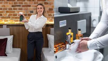 Una habitación de hotel con pared de ladrillo, una cama con ropa de cama blanca y un mostrador de recepción.