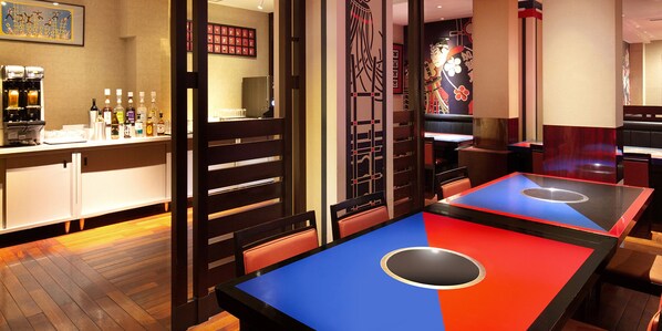 A restaurant with a bar area, booths, and a counter with various bottles. - Kagari Kisshotei (Kaga)