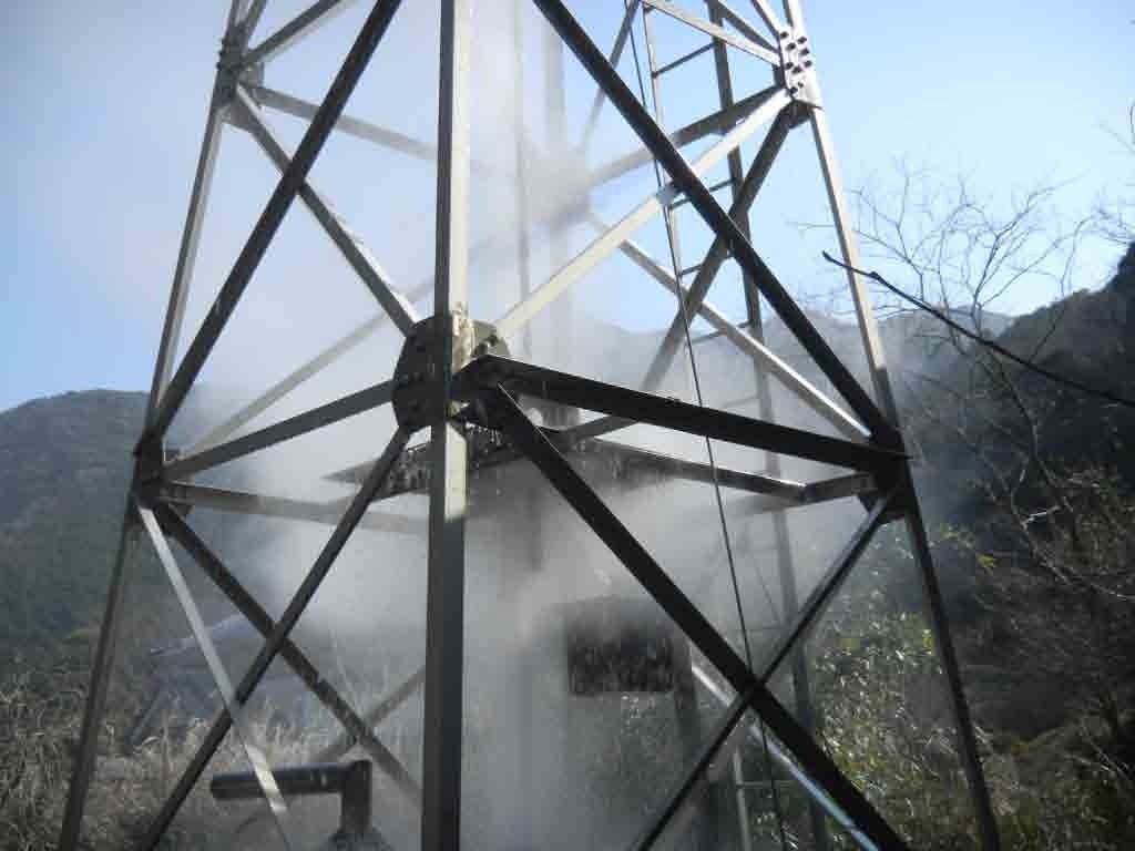 A metal tower structure with a cross-bracing design.