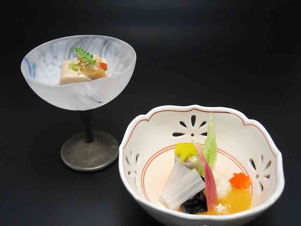 Two bowls of food with a dark background.