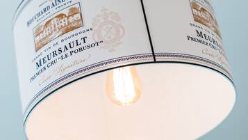 A cylindrical light fixture with a label that reads "Bouchard & Fils" and "Meursault Premier Cru 'Le Porusot'".