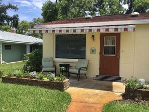 Front porch seating with retractable awning.