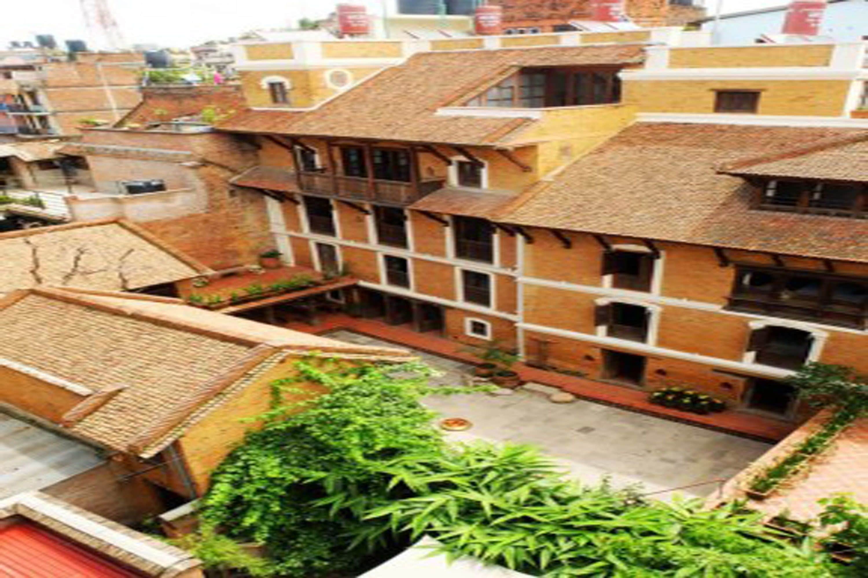 A traditional building with multiple balconies and a courtyard.
