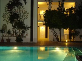 Piscina externa, piscina com cascata, guarda-sóis, espreguiçadeiras