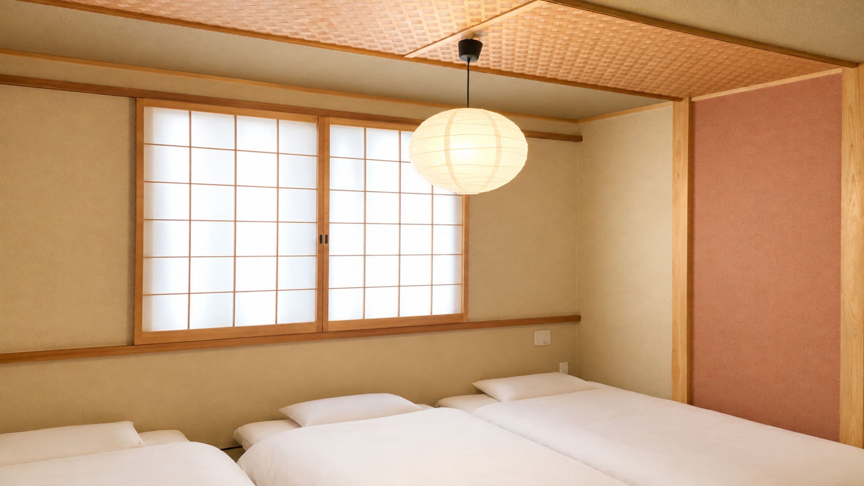 A traditional Japanese room with tatami flooring, a shoji screen, and a hanging paper lantern.