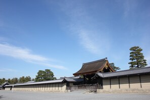 A traditional Japanese building with a curved roof and wooden structures. - Stay SAKURA Kyoto Nijo Castle West I (Kyoto)
