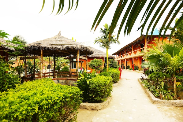 Experience a tranquil retreat amidst lush greenery and traditional architecture.
