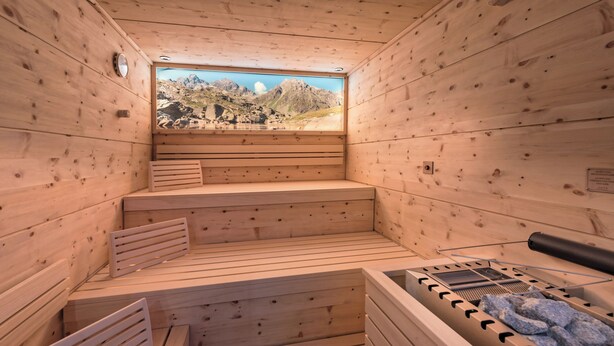 A wooden sauna with benches and a sauna table. - Hotel Alpenfeuer Montafon (Sankt Gallenkirch)