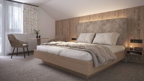 Un dormitorio moderno con una cama grande, un escritorio y una silla.