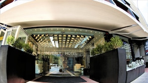 The Beverly Hotel entrance with a modern design, valet parking, and a glass facade. - Beverly Hotel Beirut (Beirut)
