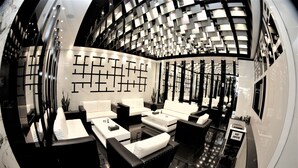 A modern interior with a curved ceiling, black and white furnishings, and a geometric wall design. - Beverly Hotel Beirut (Beirut)