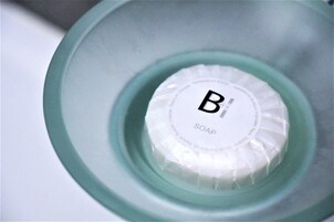 A close-up of a soap dispenser with the label "B1 SOAP" on it.