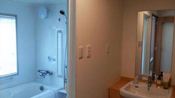 A bathroom with a bathtub, a sink, and a shower.