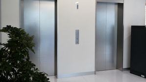 A modern elevator with a digital display, a control panel, and a number indicating the floor. - Hotel Nishimura (Fuji)