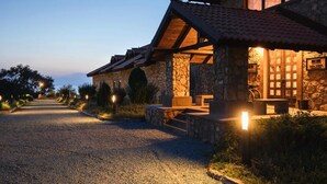 A stone building with a gravel driveway and outdoor seating area. - Tufenkian Avan Marak Tsapatagh Hotel (Tsapatagh)