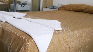 A hotel room with a bed, a wardrobe, a bedside table, and a mirror. - Beste Hotel (Bodrum)