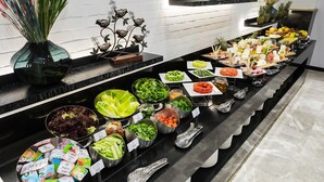 A buffet with various food items and utensils. - Dedeman Cizre (Cizre)