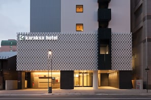A modern building with a checkered facade and the name "karaksa hotel" prominently displayed. - karaksa hotel Sapporo (Sapporo)
