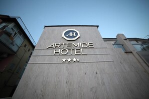 The exterior of the Artemide Hotel with a sign indicating a 4-star rating. - Hotel Artemide (Aversa)