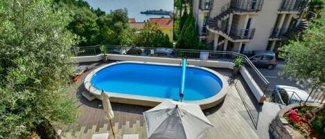 Seasonal outdoor pool, open 10:00 AM to 8:00 PM, pool umbrellas