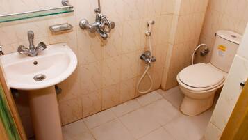 A bathroom with a sink, toilet, and shower.