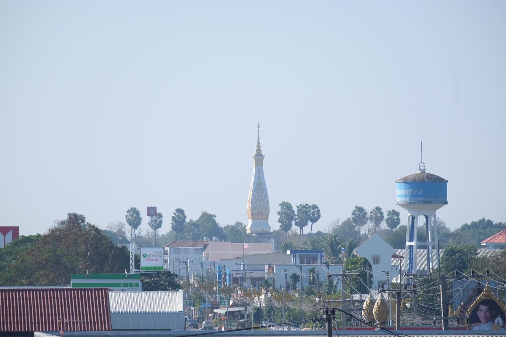 A cityscape with a prominent church spire, a water tower, and various buildings.