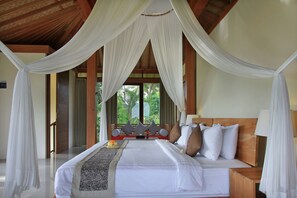 A spacious bedroom with a large bed, white bedding, and a canopy. - Kabinawa Ubud Villas by GenuineHost (Tegallalang)