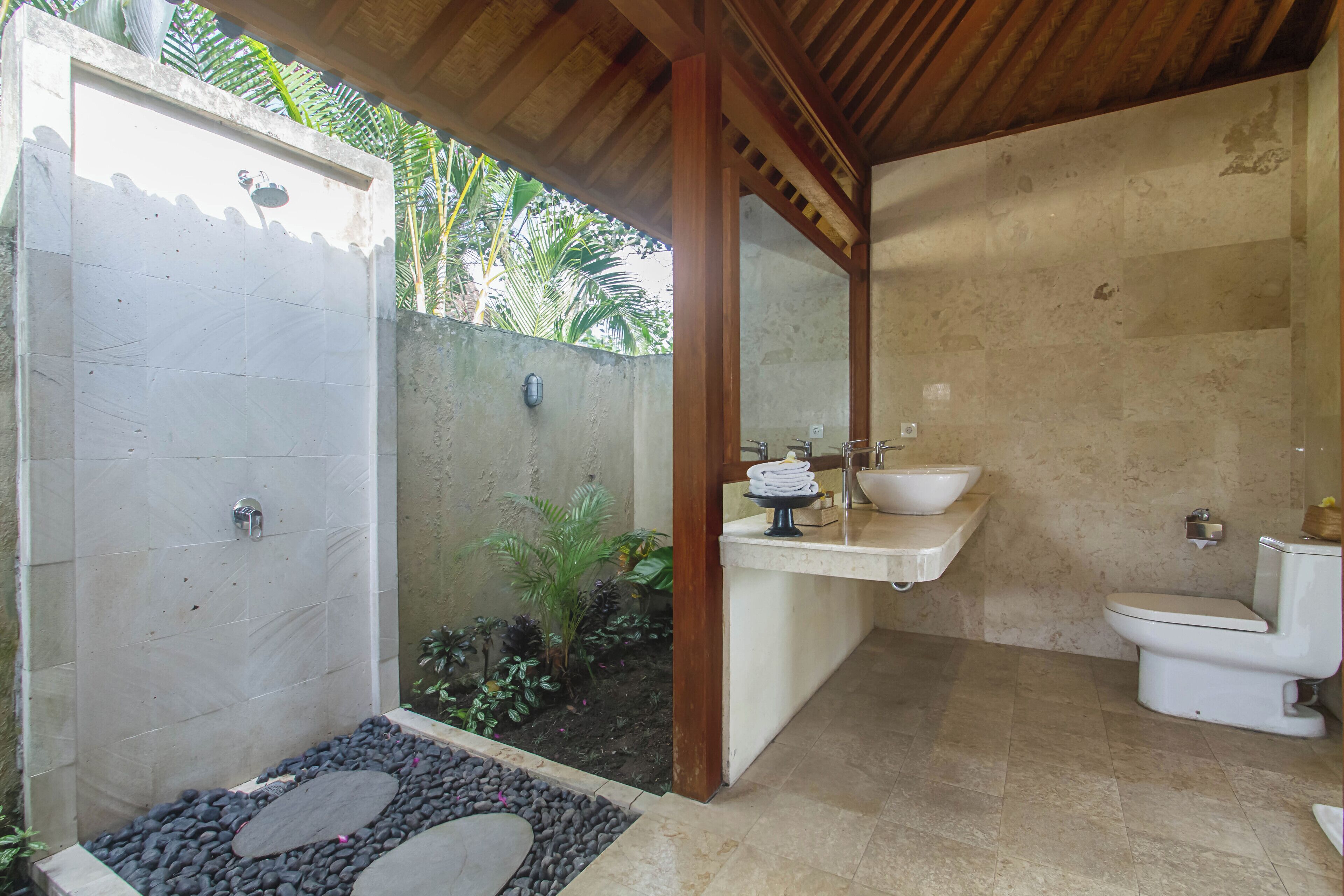 A bathroom with a shower, sink, and toilet.