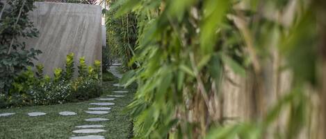 A garden pathway with stepping stones and lush greenery.