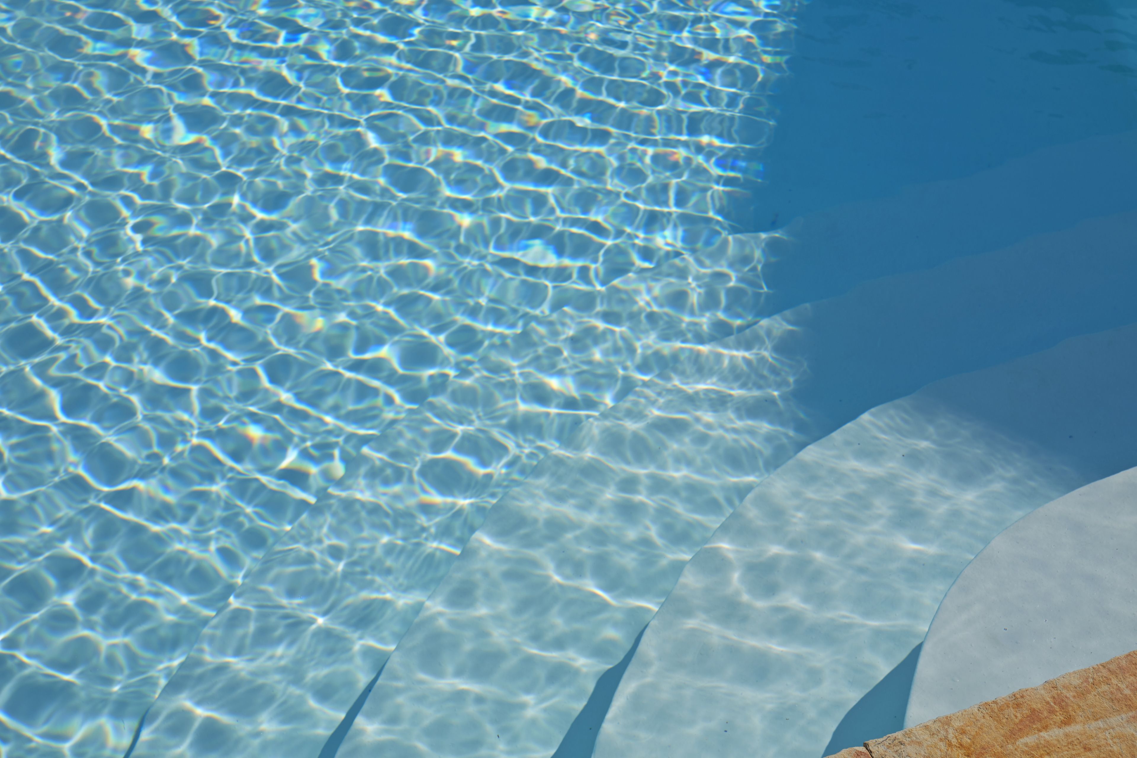 A clear pool with visible ripples and reflections.