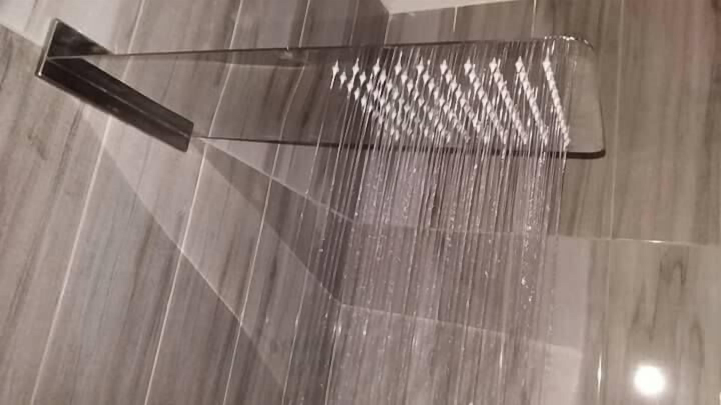 A polished marble floor with a reflective surface and a clear glass partition.