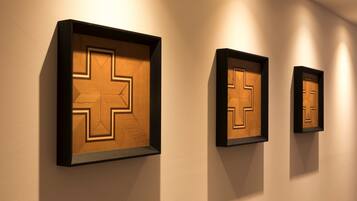 Three framed wooden panels with geometric patterns on a wall.