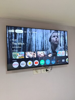 A television displaying a movie titled "The Witch" with various streaming service icons visible. - Rabbit Room (Bangkok)