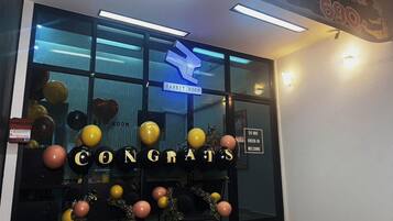 A hotel entrance with a 'CONGRATS' sign, balloons, and a 'RABBIT ROOM' sign.