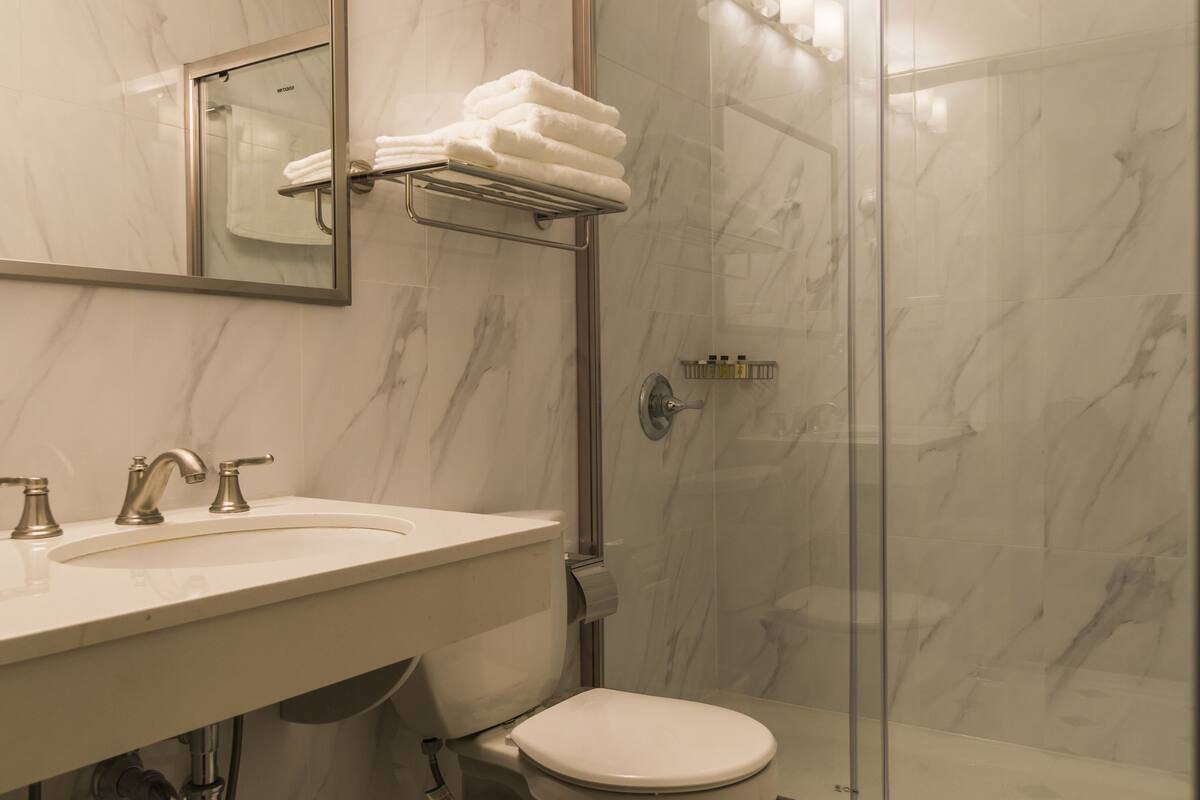 classic double room, 2 queen beds | bathroom | shower, rainfall showerhead, free toiletries, hair dryer