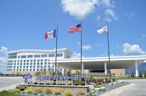 Experience the grand entrance of Rhythm City Casino Resort, featuring a covered parking area and a prominent building facade.
