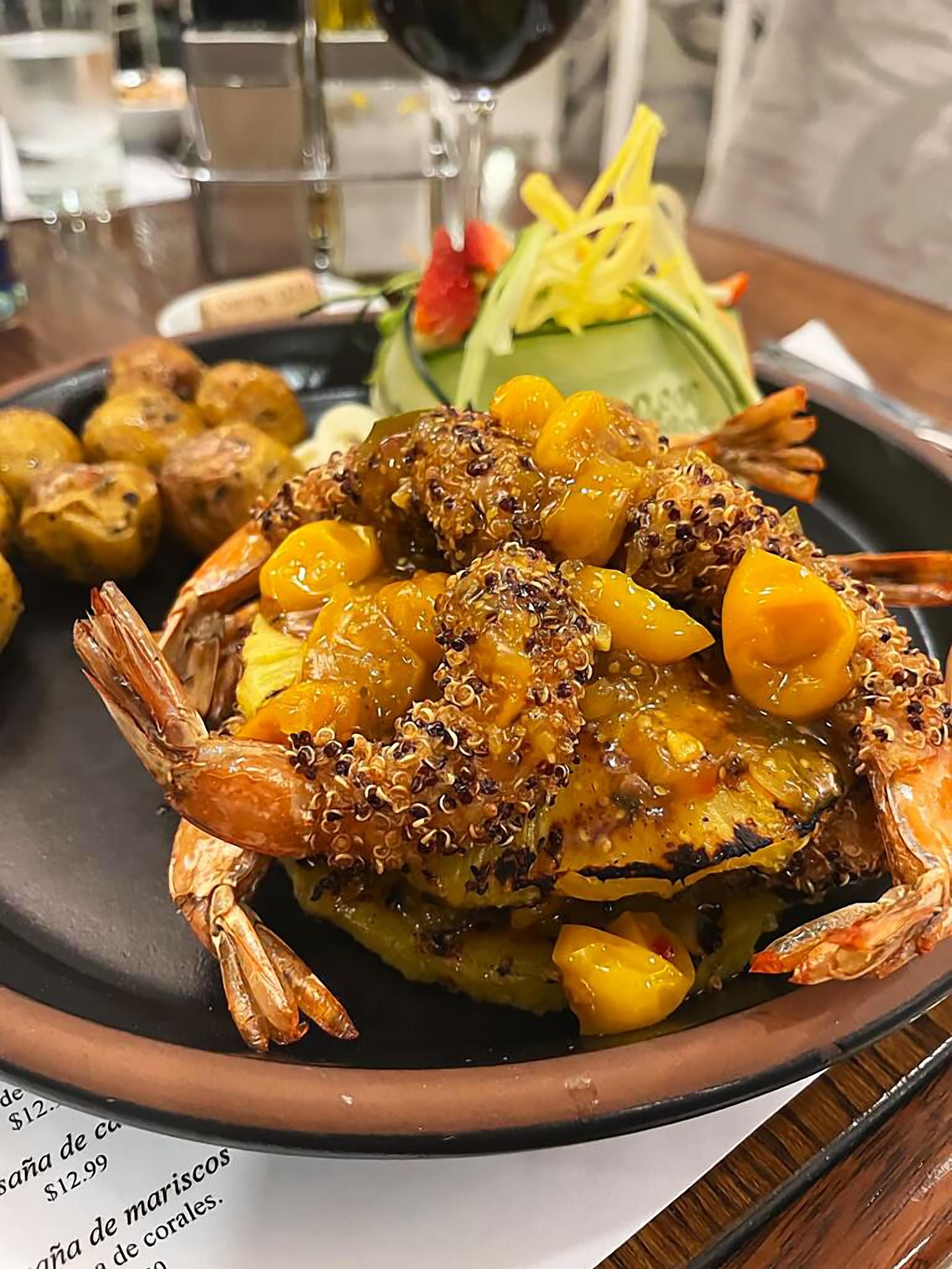 A seafood dish with shrimp and corn on a plate.