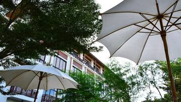 A building with balconies and large umbrellas.