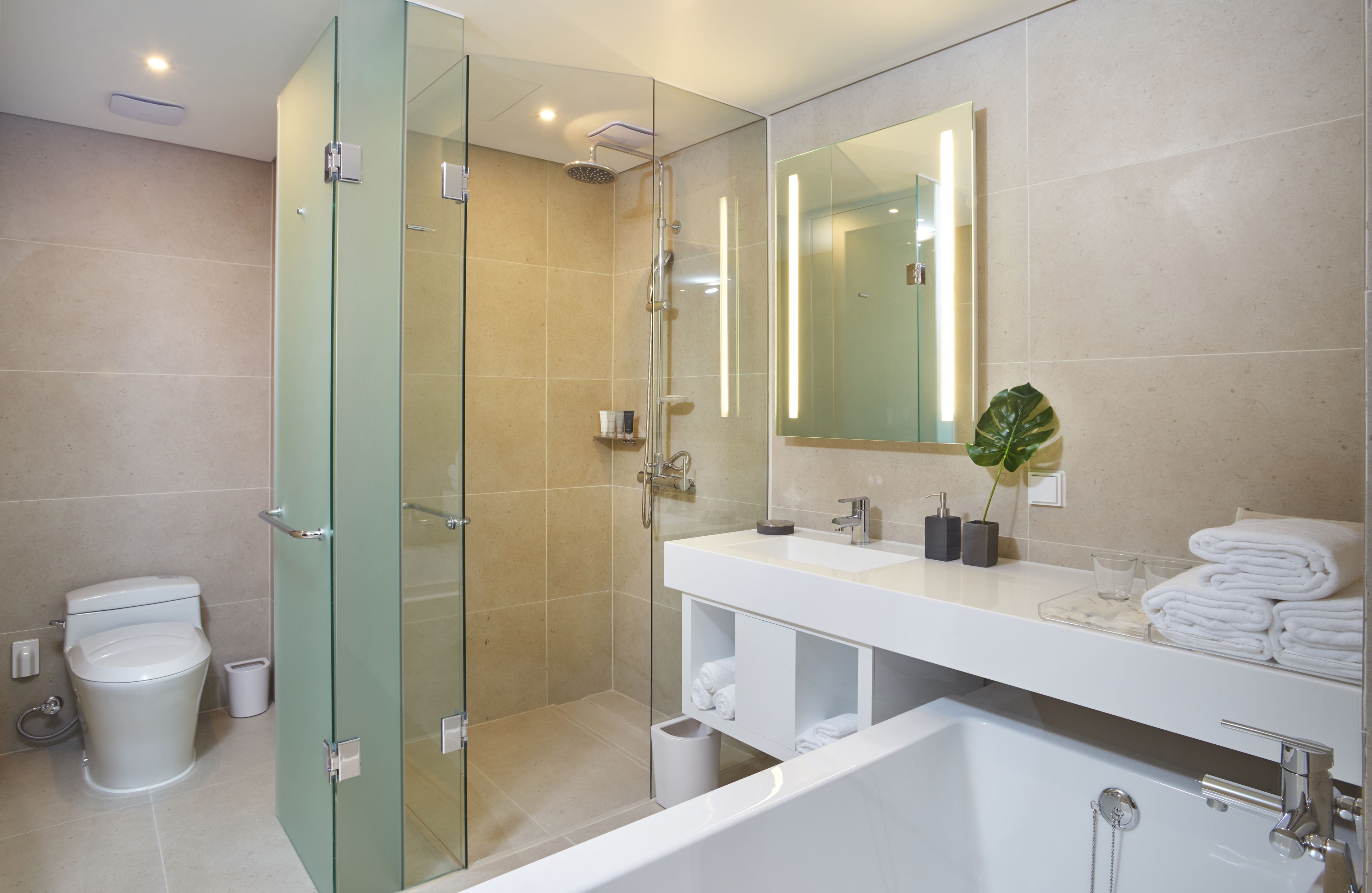 deluxe twin ocean view | bathroom | shower, eco-friendly toiletries, hair dryer, slippers