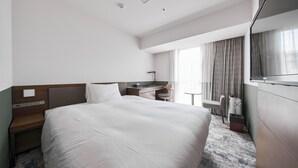 A hotel room with a large bed, a desk, a chair, a TV, and a window with curtains. - Richmond Hotel Fukuyama Ekimae (Fukuyama)