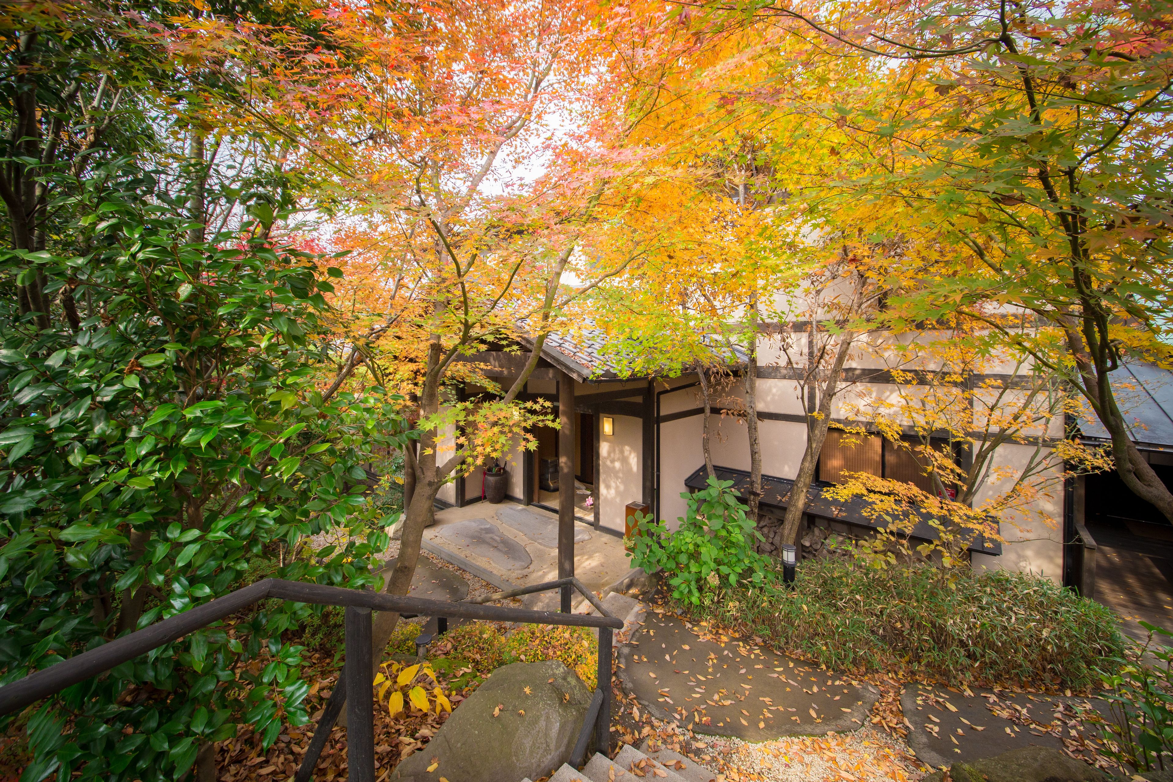 A traditional Japanese building with a wooden staircase leading to a covered entrance.