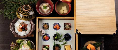 A variety of Japanese dishes arranged on a table, including sushi, sashimi, and other delicacies.