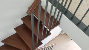 A spiral staircase with wooden steps and metal railings.