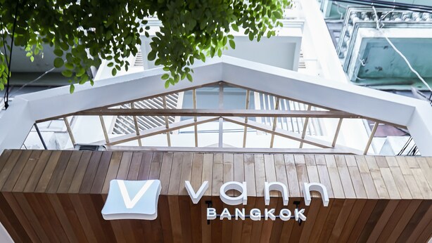 The exterior of Vann Bangkok with a modern design, large glass windows, and a visible seating area inside. - Vann Bangkok Boutique House (Bangkok)