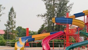 A water park with multiple slides and a pool. - Goldenland Resort (Chok Chai)