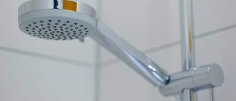 A showerhead with a circular spray pattern and a chrome finish.