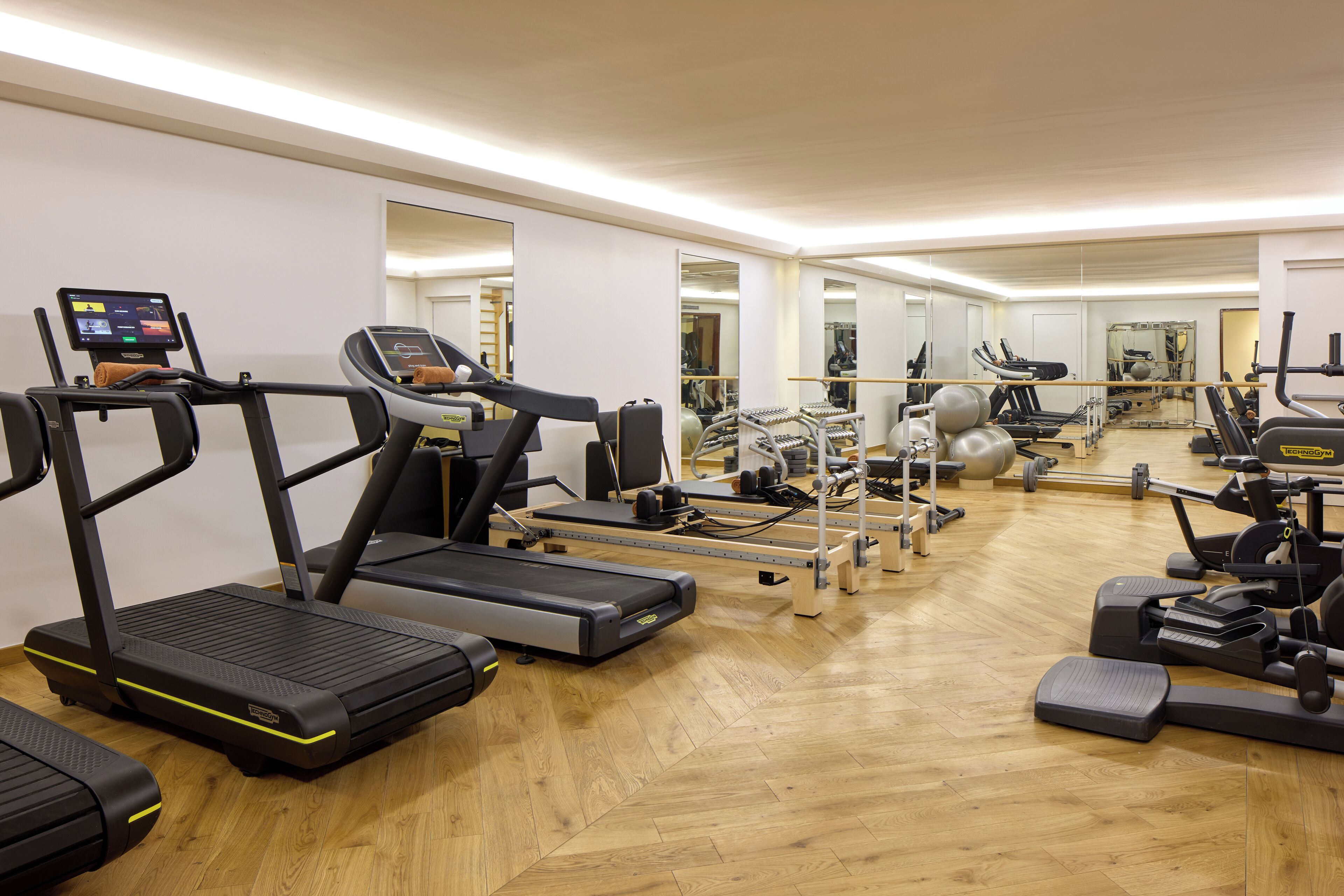A gym with treadmills, exercise bikes, and other fitness equipment.