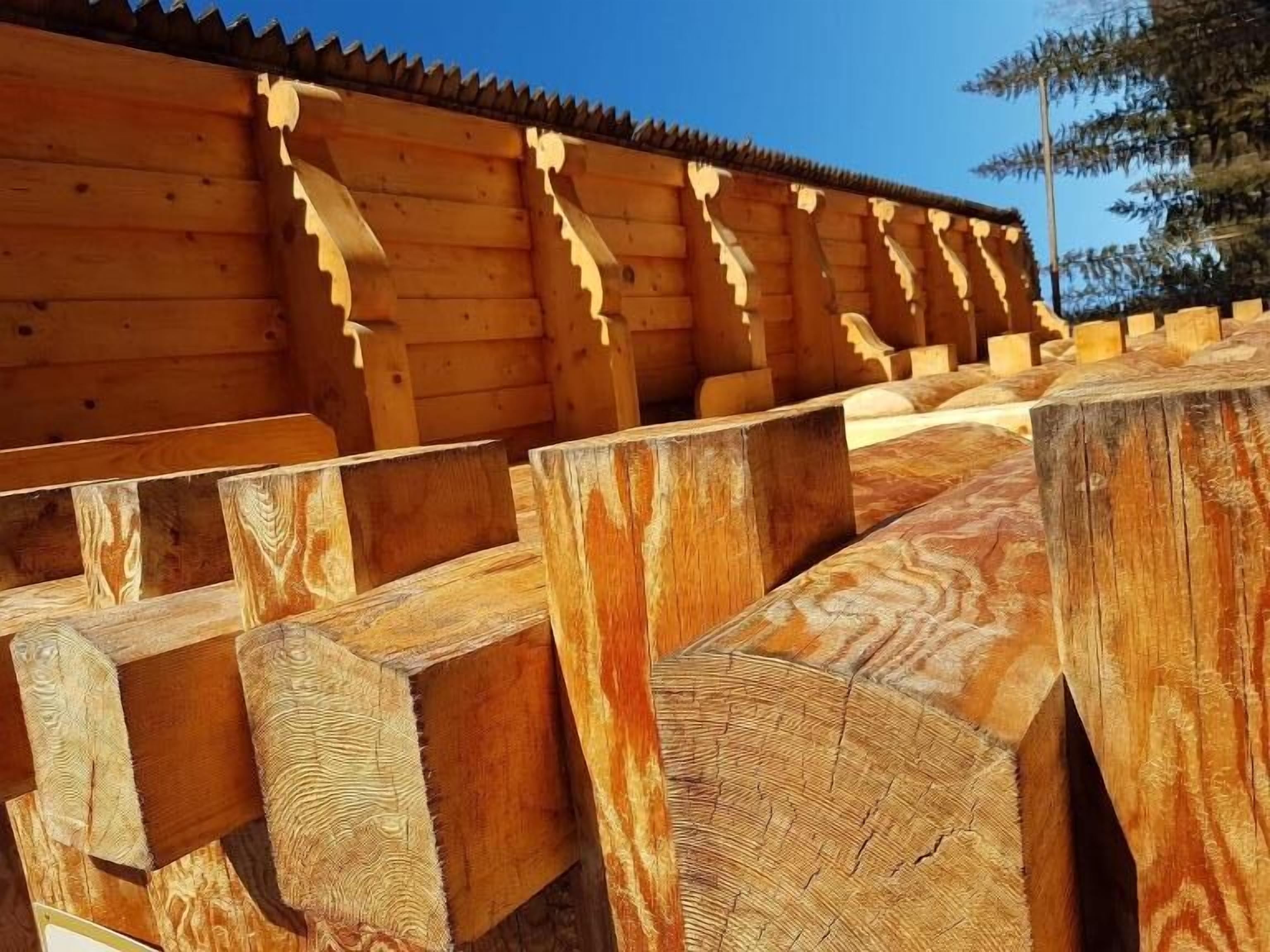 A wooden structure with a sloped roof and vertical supports.