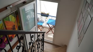 Step out to a balcony with a table and chairs, perfect for taking in the views.