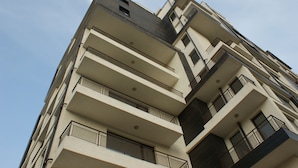A multi-story building with balconies, a clear sky, and a modern architectural design. - ATM Aparts Sofia (Sofia)